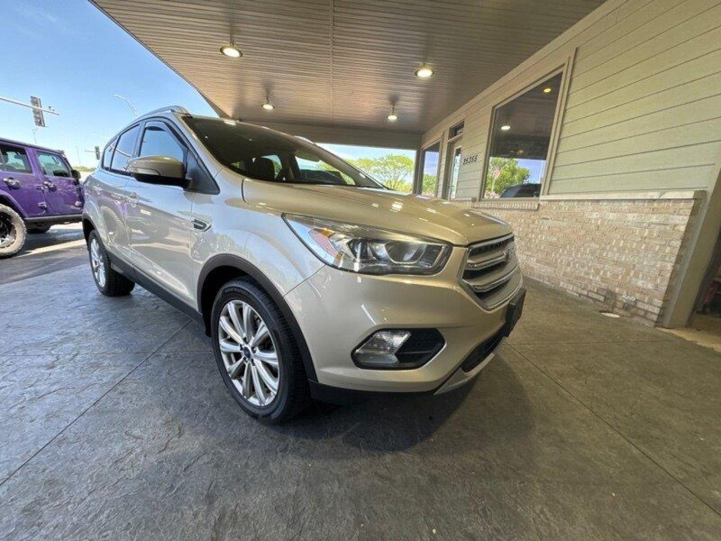 2017 White Gold Ford Escape Titanium (1FMCU0J96HU) with an 2.0 engine, Automatic transmission, located at 25355 Eames Street, Channahon, IL, 60410, (815) 467-1807, 41.429108, -88.228432 - Looking for an SUV that's tough, stylish, and fast? Look no further than the 2017 Ford Escape Titanium! This baby is powered by a 2.0 engine that will have you zooming down the road like nobody's business. But that's not all - this ride is loaded with factory default features that will make your jaw - Photo#0